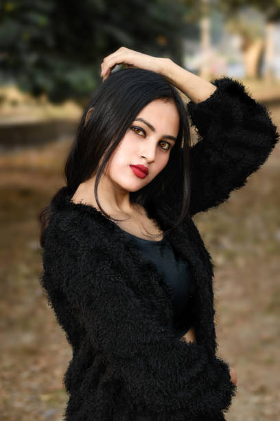 Portrait of very beautiful young attractive brunette Indian woman wearing black outfit posing fashionable in a blurred background. Lifestyle and Fashion. stock photo