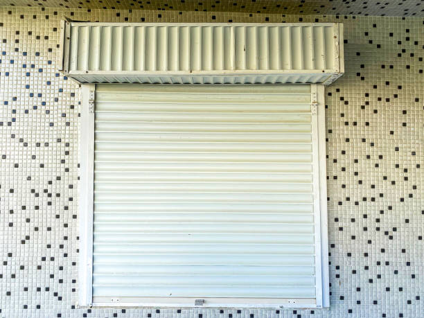 istock Closed white shutter in front of the house. 1301750834