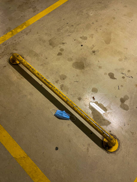 istock Surgical mask thrown in the parking lot. 1301751225