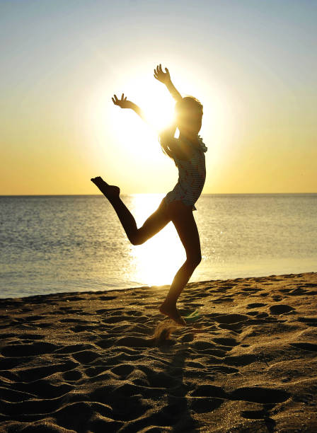 istock Pretty girl has fun on beach 1301751615