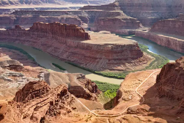The park is near City of Moab. In the foreground Potash Road (White Rim Road) follows the canyon rim.