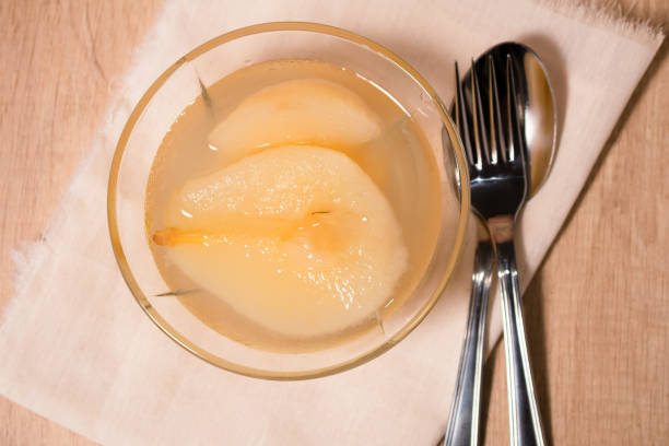 Fresh half Pears Served with sweet syrup. Wooden background.