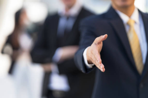 istock Businessman with an open hand ready for handshake 1301754502