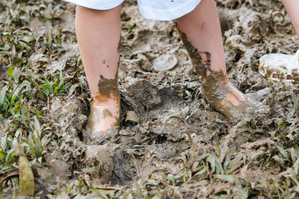 istock a toddler playing with the mud 1301755068