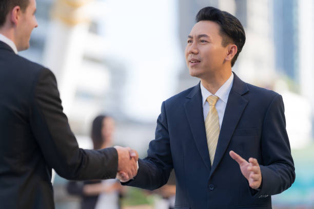 istock Handshake of two businessmen on the background 1301755298