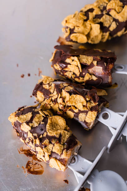 istock frozen banana covered with chocolate and sprinkled with corn flakes 1301755449