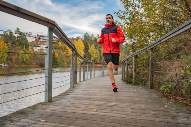 istock Young man trail running in the forest. 1301756633