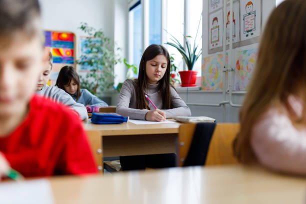 istock Children writing in the classroom 1301757856