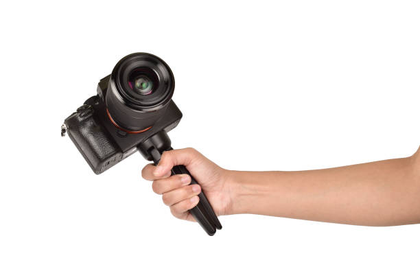 istock Mirrorless camera in hand isolated on white background with clipping path 1301757874