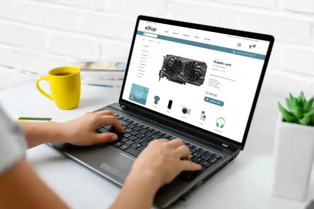 Purchase computer components online concept. Graphic card on modern ecommerce web site on laptop computer
