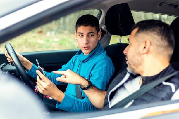 istock Teenage boy having driving lesson with male instructor 1301758900