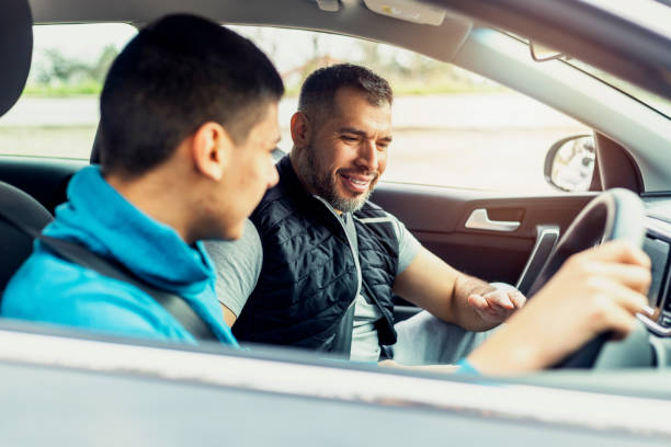 istock Teenage boy having driving lesson with male instructor 1301758983