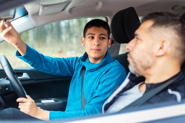 istock Teenage boy having driving lesson with male instructor 1301759000