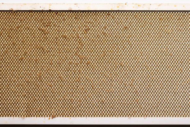 dirty clogged cooker hood filter from domestic kitchen. above view.