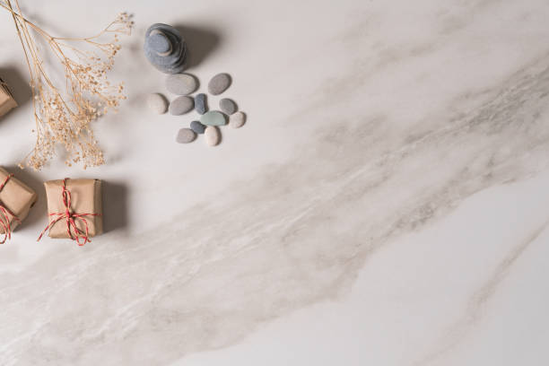 istock white zen balance stones and gift box on marble table, top view. 1301761550