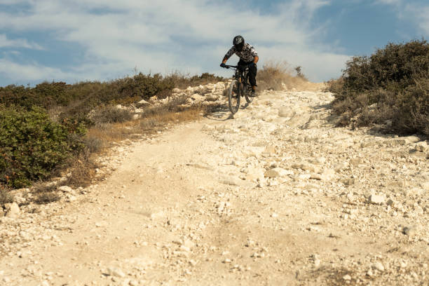 istock Professional bike rider during downhill ride on his bicycle 1301764090