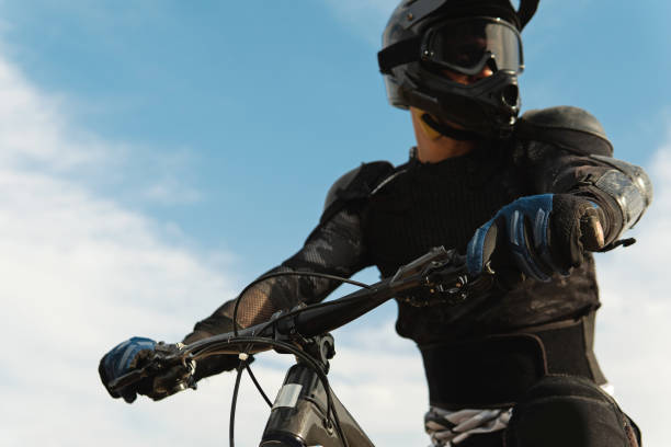 istock Downhill rider fully equipped with protective gear riding his bicycle 1301764502