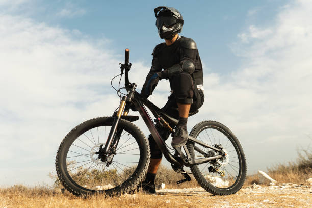 istock Downhill rider fully equipped with protective gear and his bicycle 1301765252