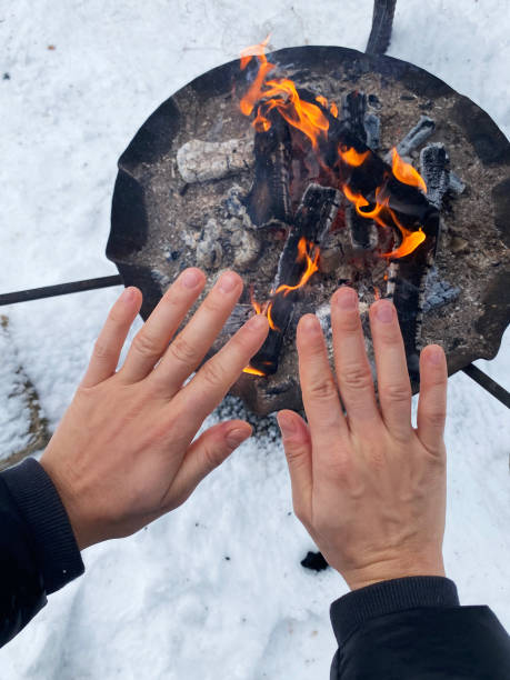 istock Woman warming up her hands by the fire pit 1301765945