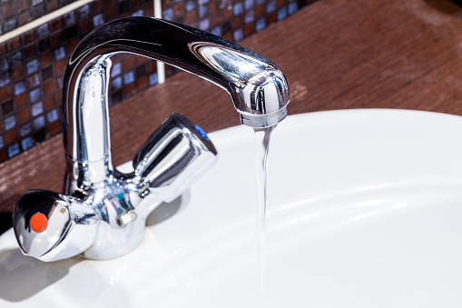 faucet at domestic bathroom with low water pressure. leaky tap repair.