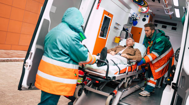 istock Confident and professional doctors unloading an ill patient from an ambulance car on a stretcher near the hospital building 1301767386