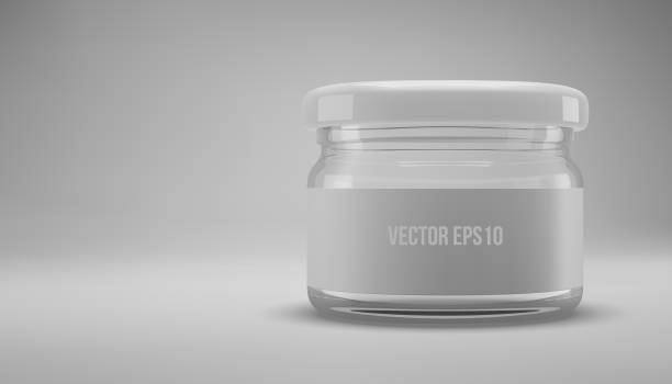 istock Small glass jam jar with a lid. A transparent jar with a white lid and label. 1301769038