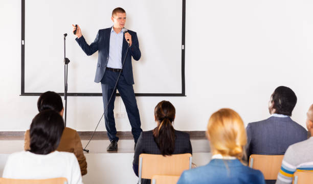 istock Male coach giving speech at conference hall 1301772973