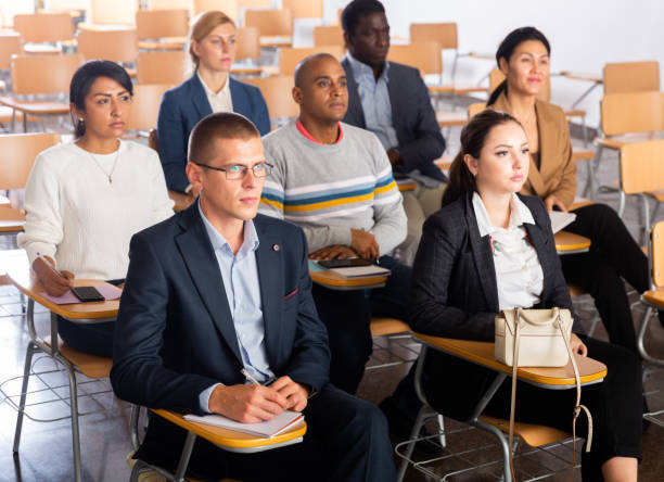 istock Business people listening to speaker at conference 1301773003