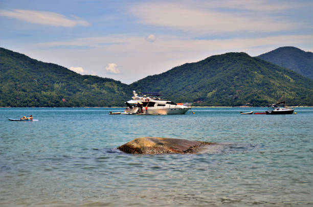 Ubatuba, São Paulo, Brazil, 27, January, 2021: A motorboat stopped at Domingas Dias beach