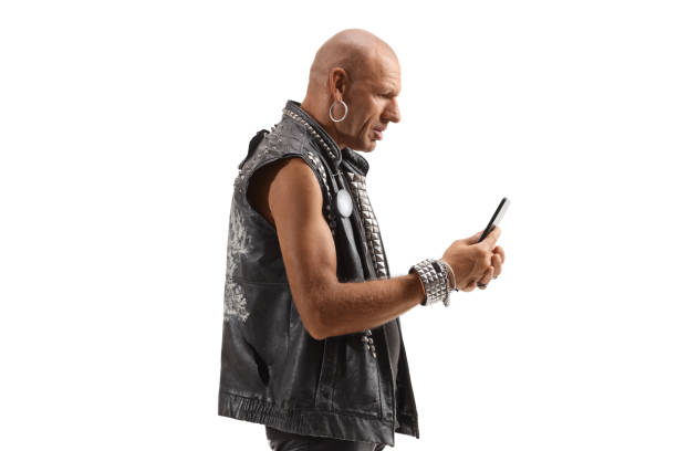 istock Punk in leather vest standing and typing on a mobile phone 1301773260