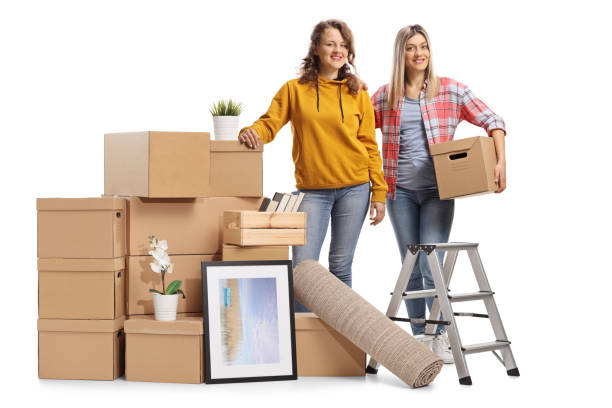 istock Two young female posing with a pile of cardbox boxes prepared for removal 1301773287