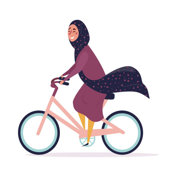 istock Muslim woman in hijab rides a bicycle 1301773904