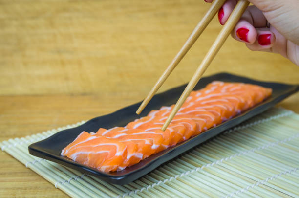 Traditional salmon carpaccio with olive oil sauce and lemon juice