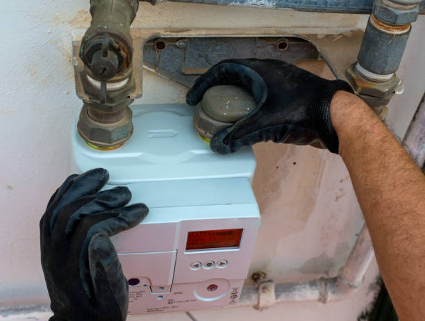 istock Worker insert the seals to the fitting between the pipe and gas meter. Selective focus 1301775240