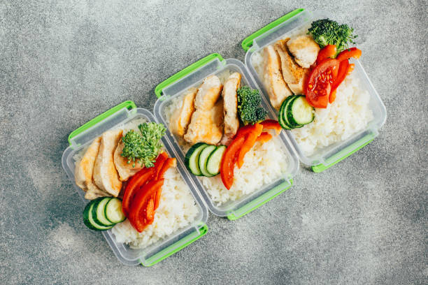 istock lunch boxes with food on gray background 1301775305