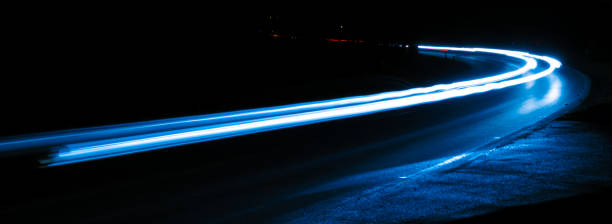 istock blue car lights at night. long exposure 1301775896