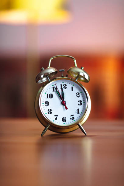 istock old gold alarm clock - 12 O'Clock 1301777076