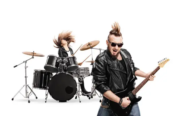 Guitarist and female drummer in a punk band performing isolated on white background