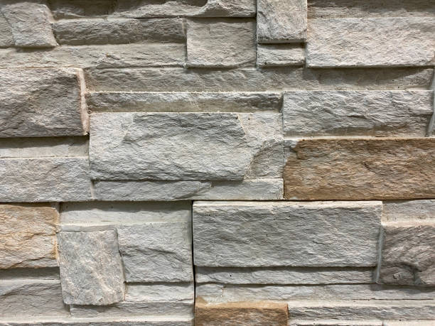 istock Grey and brown stone background, stand wall pattern texture. Brickwork. Construction detail made of bricks 1301781342