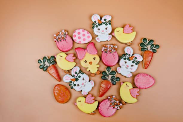 istock Closeup of variation of different Easter sugar cookies decorated with royal icing. Eggs, bunny, carrots and chicken on yellow background. Lovely sweet gift or postcard 1301781477
