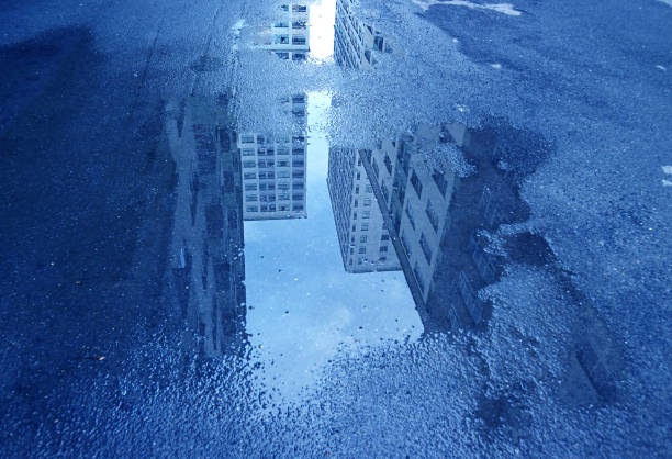 istock Pop Art Style Blue Colored High Buildings After Rain Reflecting on the Puddle 1301782653