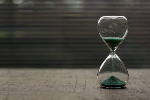 istock Hourglass with blue green sand 1301784622