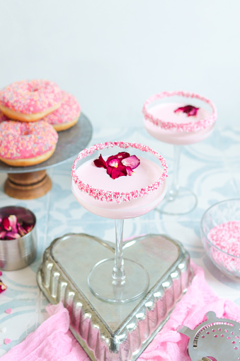 Pink strawberry cream Cocktail Drink with sugar sprinkles and rose petals for girls night