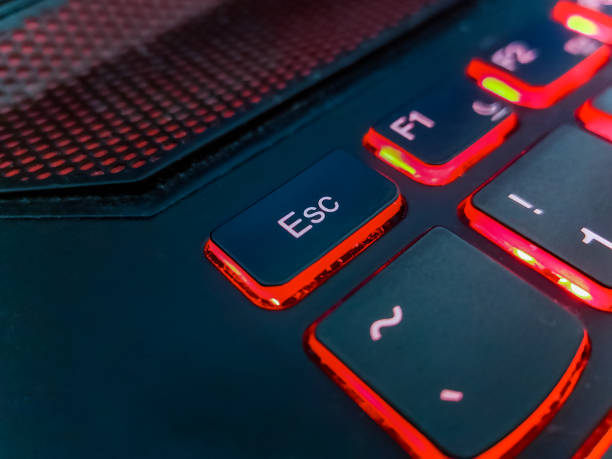istock Keyboard of laptop highlighted by red lights 1301789053