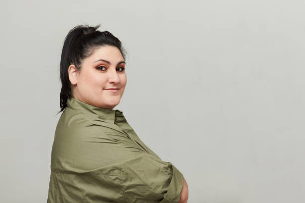 One woman in profile with arms crossed over chest. Studio portrait
One woman in profile with arms crossed over chest. plus size photos stock pictures, royalty-free photos & images