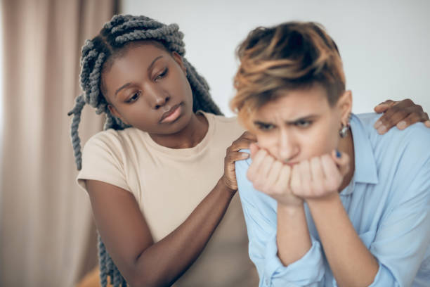 istock Same sex couple having an argument and looking unhappy 1301790122