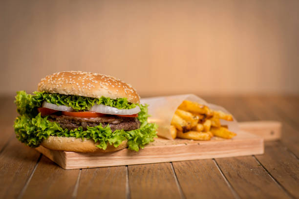 istock Delicious hamburger with vegetables on wooden board 1301791441