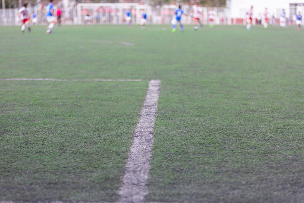 istock Soccer field in the background kids playing game 1301791796
