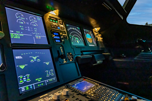 A close up of the cockpit of a modern jet airliner.