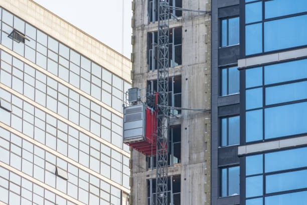 istock Construction elevator outside the facade of a multi-storey building under construction. 1301793310